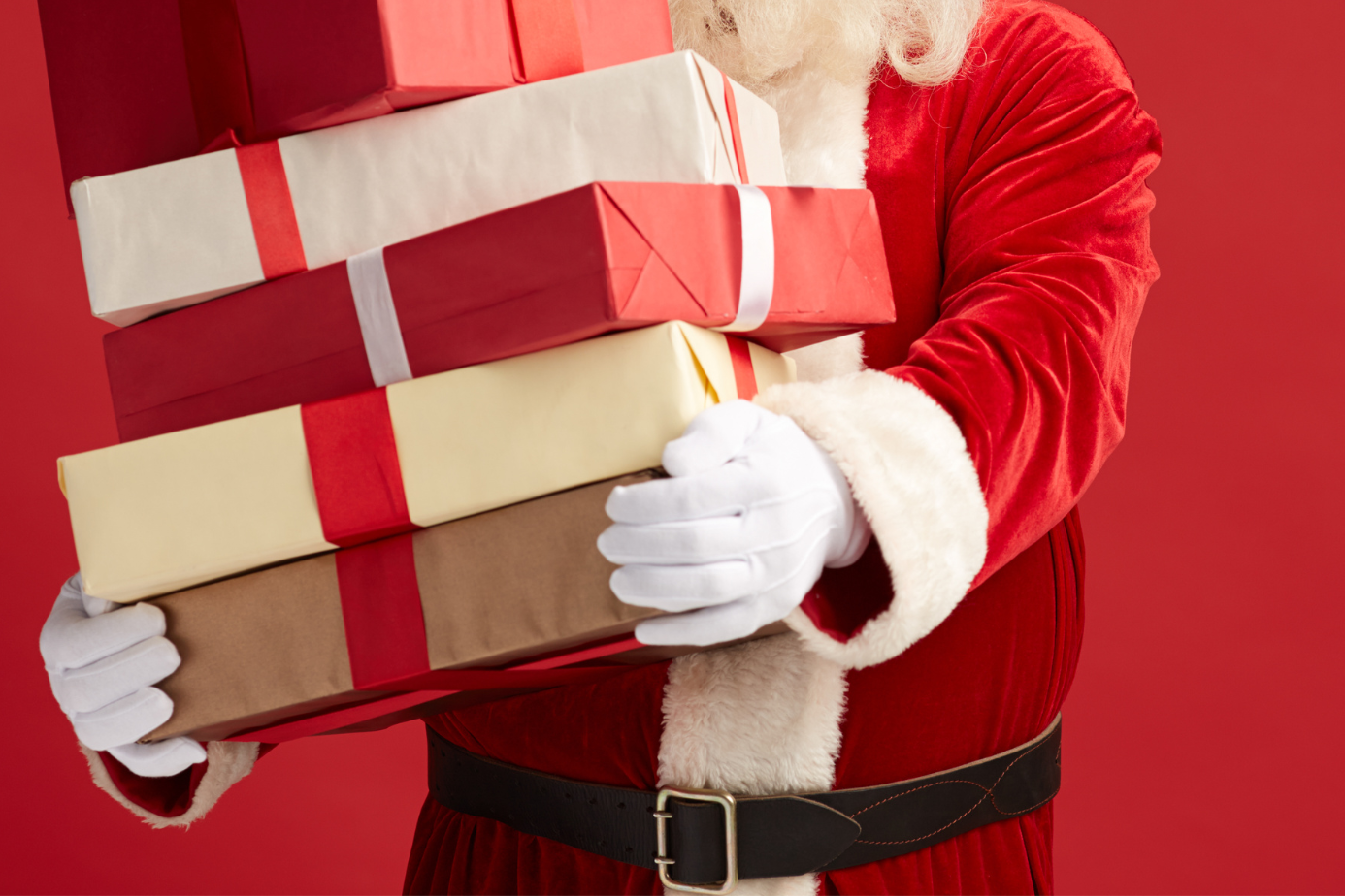 Real-life santa: A Santa figure holds presents in front of him.