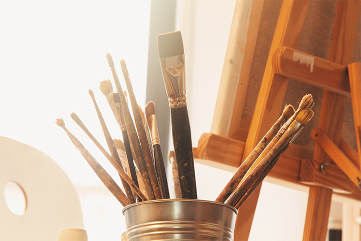 Never Give Up: A paint can appears with brushes.