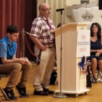 Steve Gonyea, a member of the LIFEPlan Member and Family Advisory Council speaks at the event. A man stands at a podium as others look on.