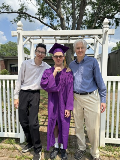 LIFEPlan Member Aidan McNerney-Rivera taking graduation photo with family and friends.
