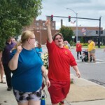 Two marchers throw their fists in the air in celebration of the ADA. Two marchers throw their fists in the air in celebration of the ADA.